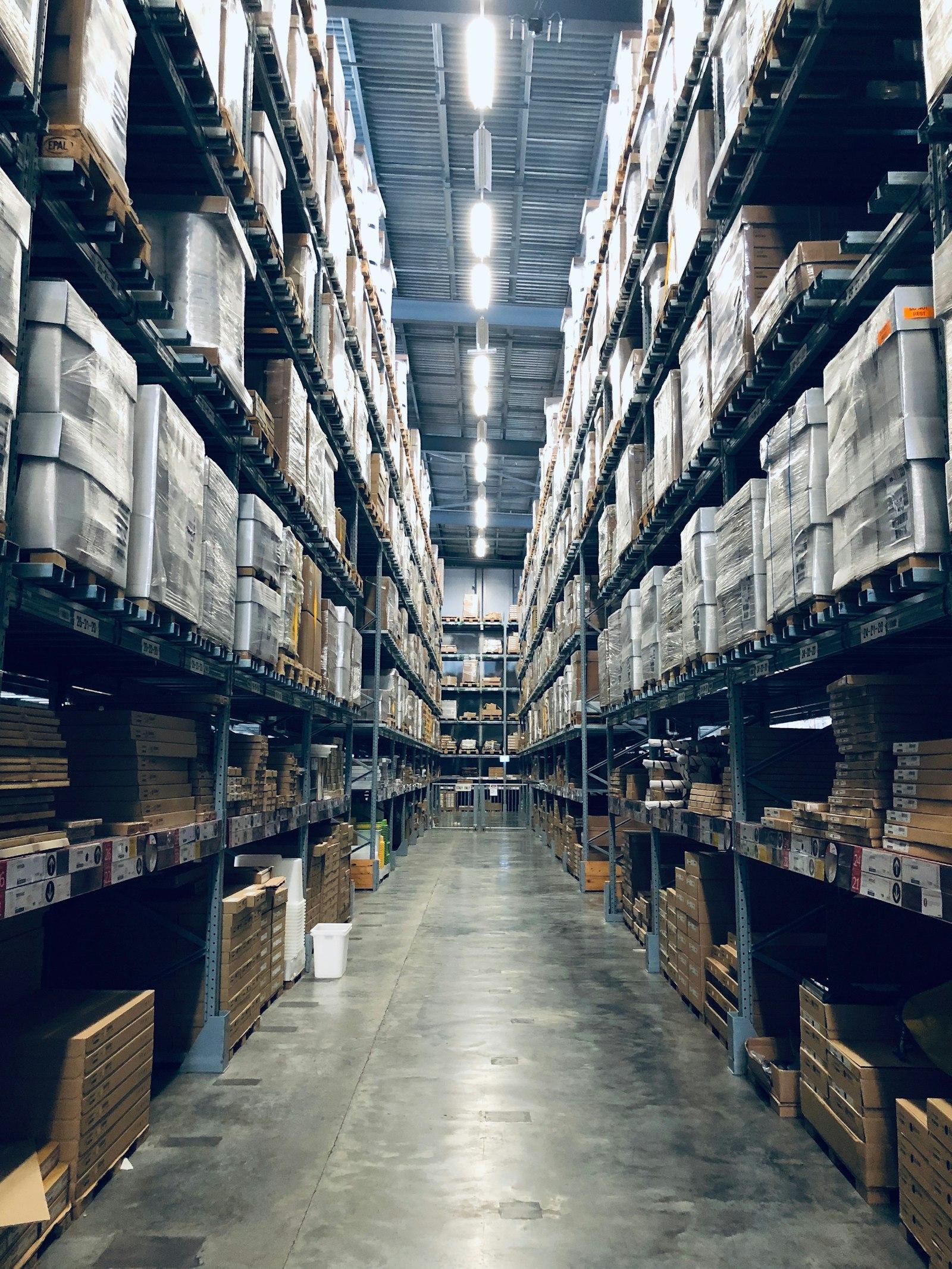 Rows of stocked warehouse shelving stretching into the distance